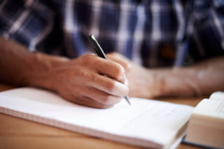 Man writing in notepad